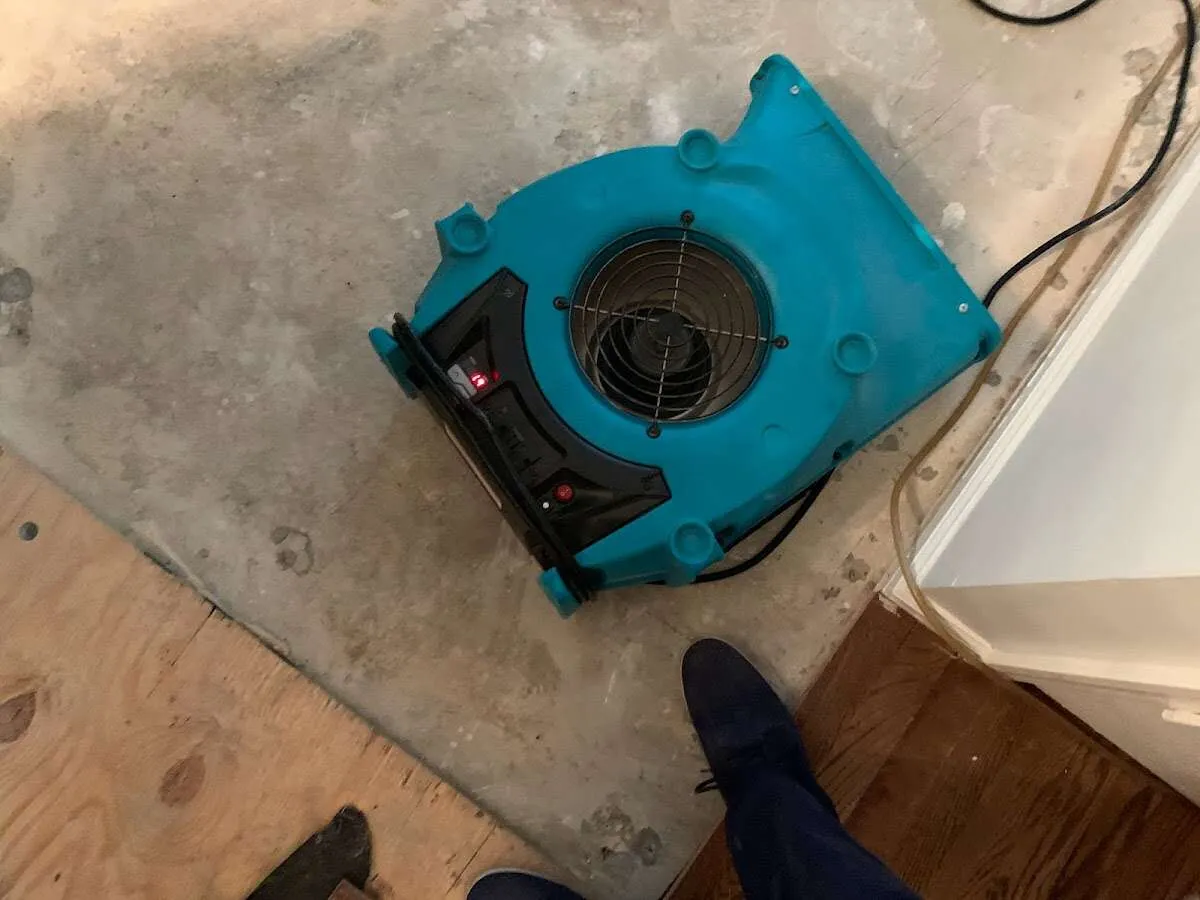 Air mover drying subfloor during Leak Detection & Repair in Kittery